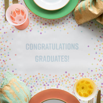 Close-up of the Confetti Sprinkles Personalized Runner under a festive table setting, with &quot;CONGRATULATIONS GRADUATES!&quot; printed in light blue.