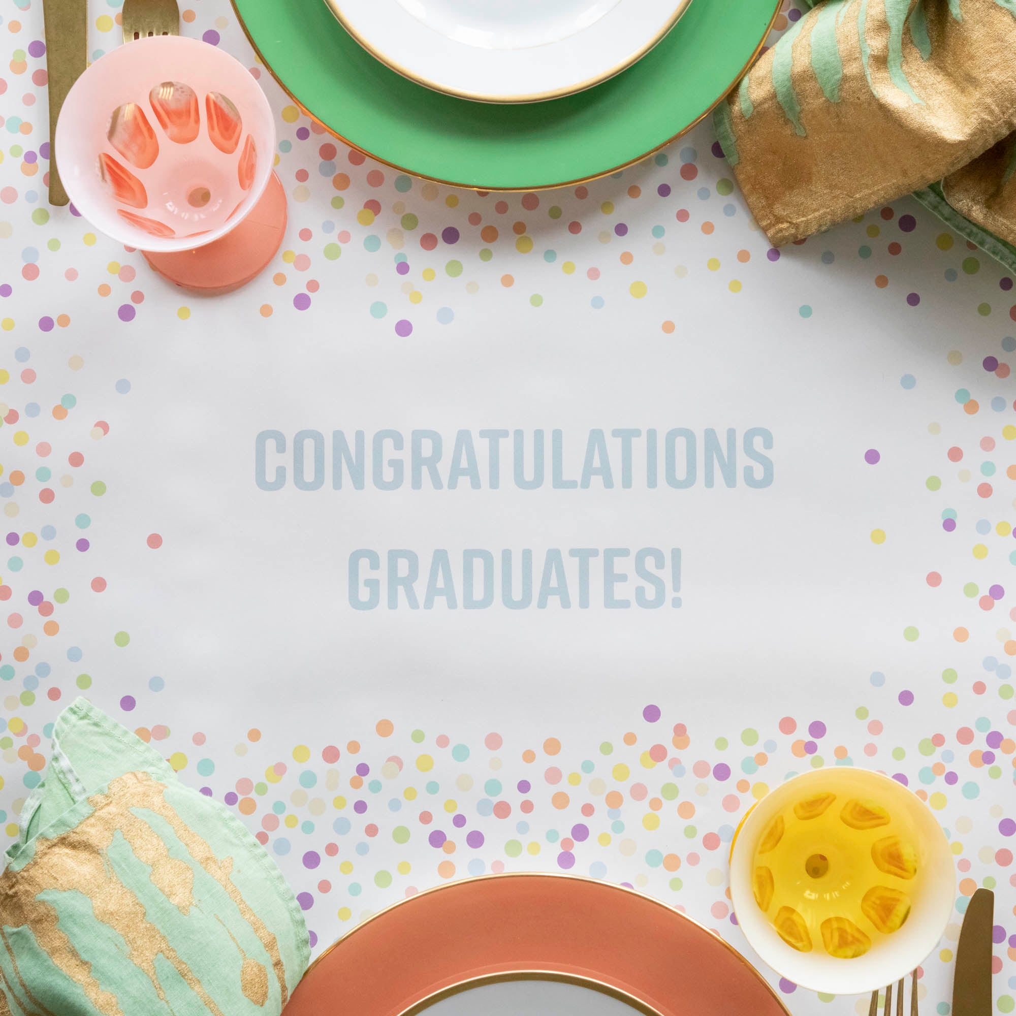 Close-up of the Confetti Sprinkles Personalized Runner under a festive table setting, with "CONGRATULATIONS GRADUATES!" printed in light blue.