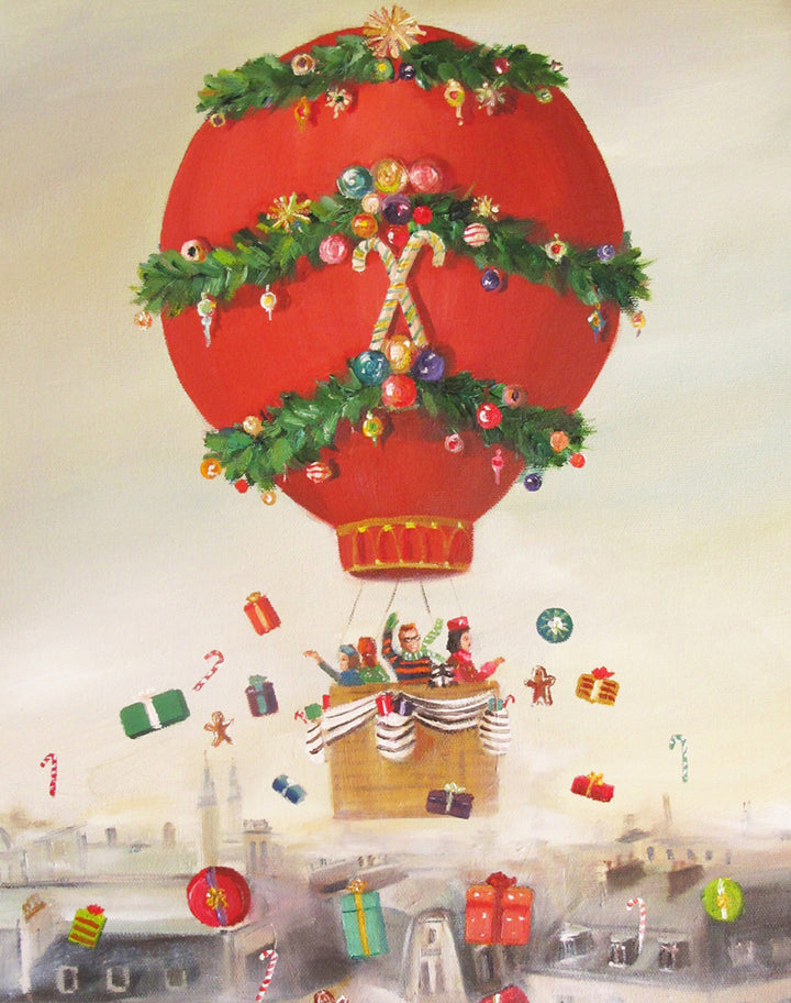 A whimsical painting by Janet Hill, &quot;The Peppermint Family Christmas Balloon Ride Small Art Print&quot; of a red hot air balloon decorated like a Christmas tree, floating over a cityscape, with gifts and ornaments suspended in the air around it.