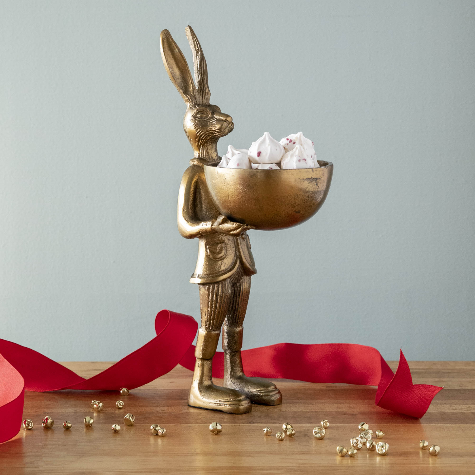 A well-dressed Accent Decor Hare Dishstand holding a bowl of peppermint meringues.