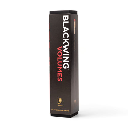 A stack of Blackwing Volume 20- Tribute to Tabletop Games pencils with gold lettering and distinctive square erasers on a black background.