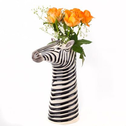 A set of Quail zebra ceramic vases on a wooden table.