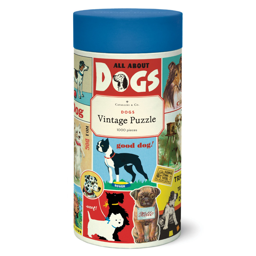 A Dog Puzzle from Cavallini Papers &amp; Co, designed with vintage illustrations and featuring various dog breeds on the packaging.