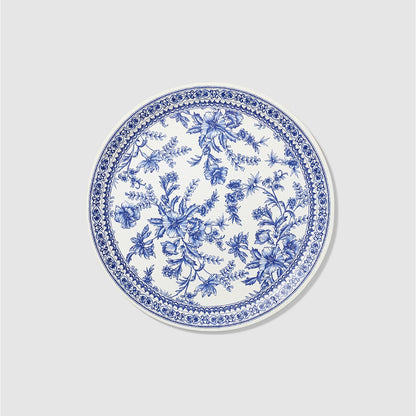 A Blue French Toile Paper Party Dinnerware plate with floral designs, inspired by the French countryside. This elegant piece of Blue French Toile Paper Party Dinnerware from Coterie Party Supplies is adorned with intricate blue patterns.