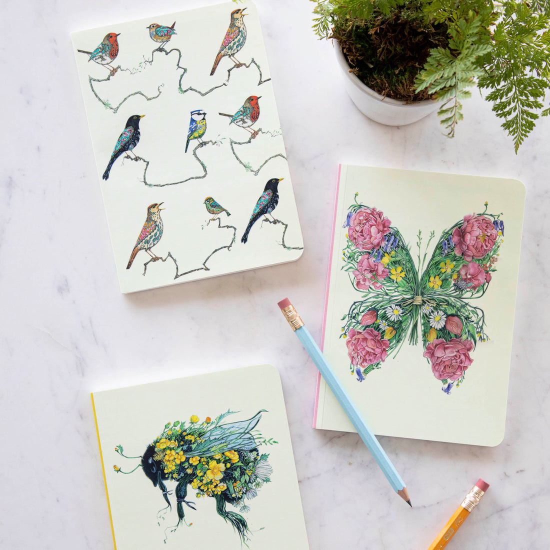 A Butterfly Perfect Bound Notebook with a butterfly and flowers on it, crafted by British papermakers on luxury cream stock by The DM Collection.