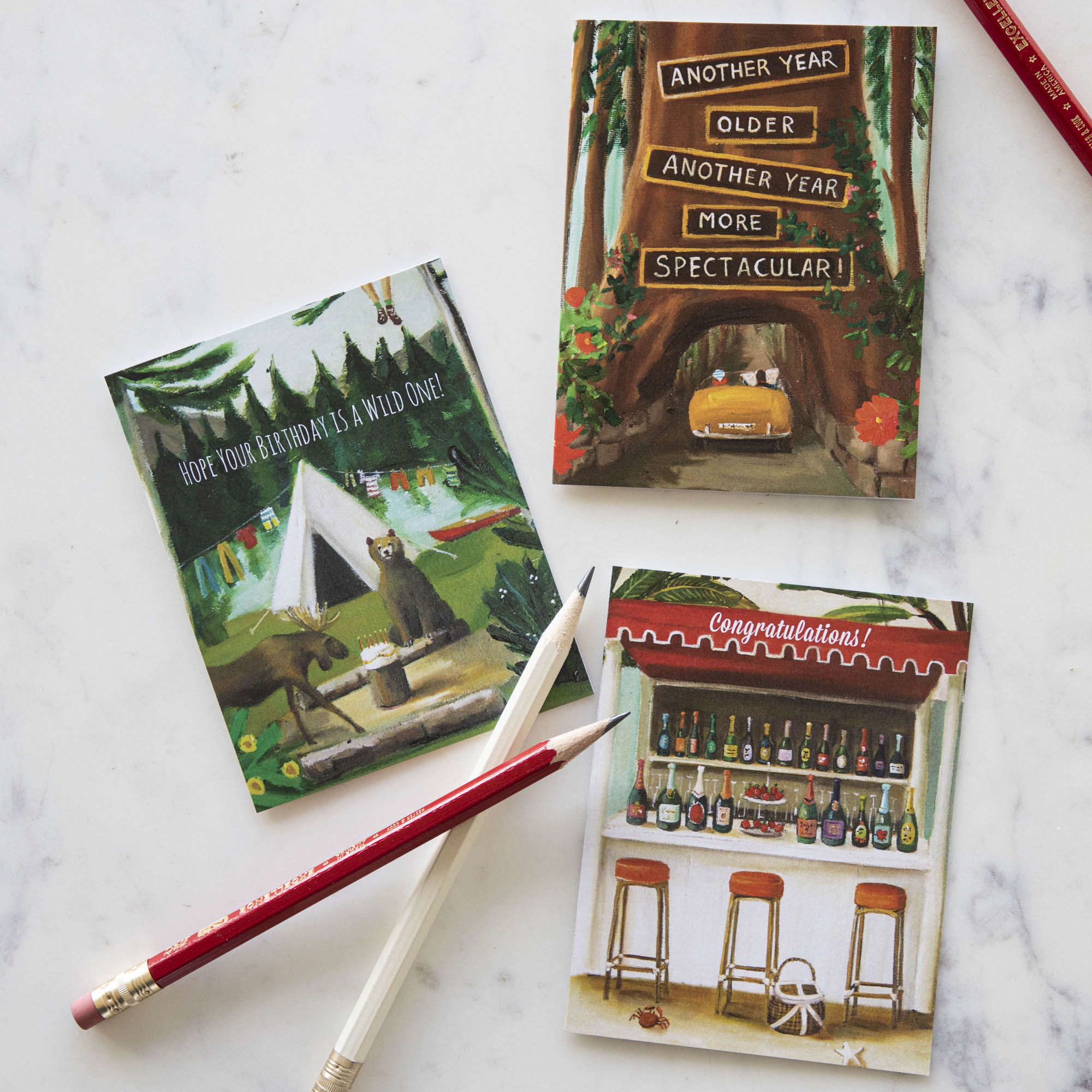 A set of Redwood Birthday Greeting Cards by Janet Hill, with a red pen and a pencil, featuring a painting style by a Canadian fine artist on recycled card stock.