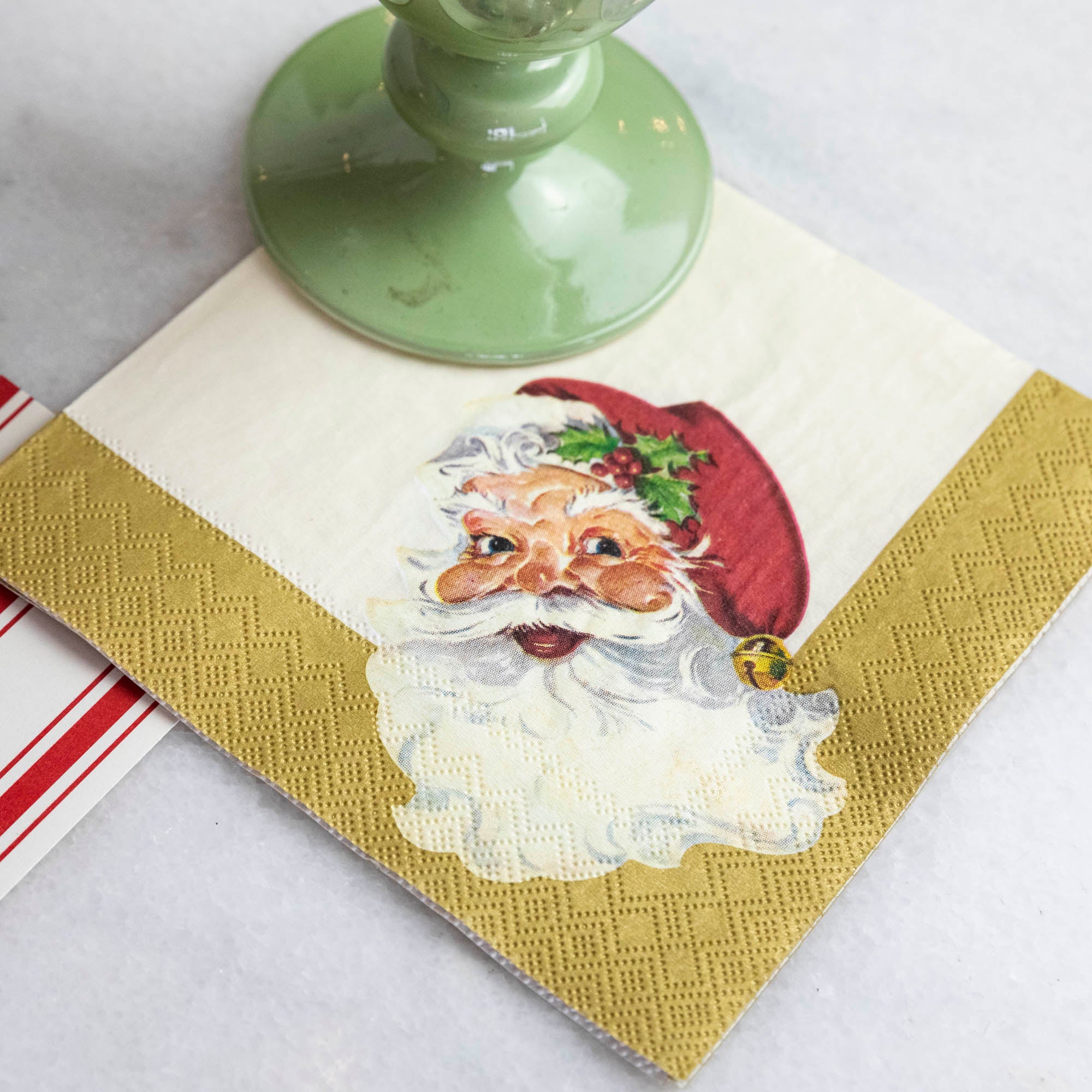 Close-up of a Santa Cocktail Napkin under a glass.