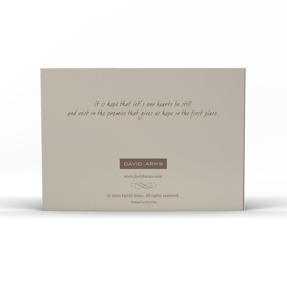 A "Hope" (Scrabble) notecard with a hummingbird illustration and the word "hope" spelled out with letter tiles rests on a woven surface. (David Arms)