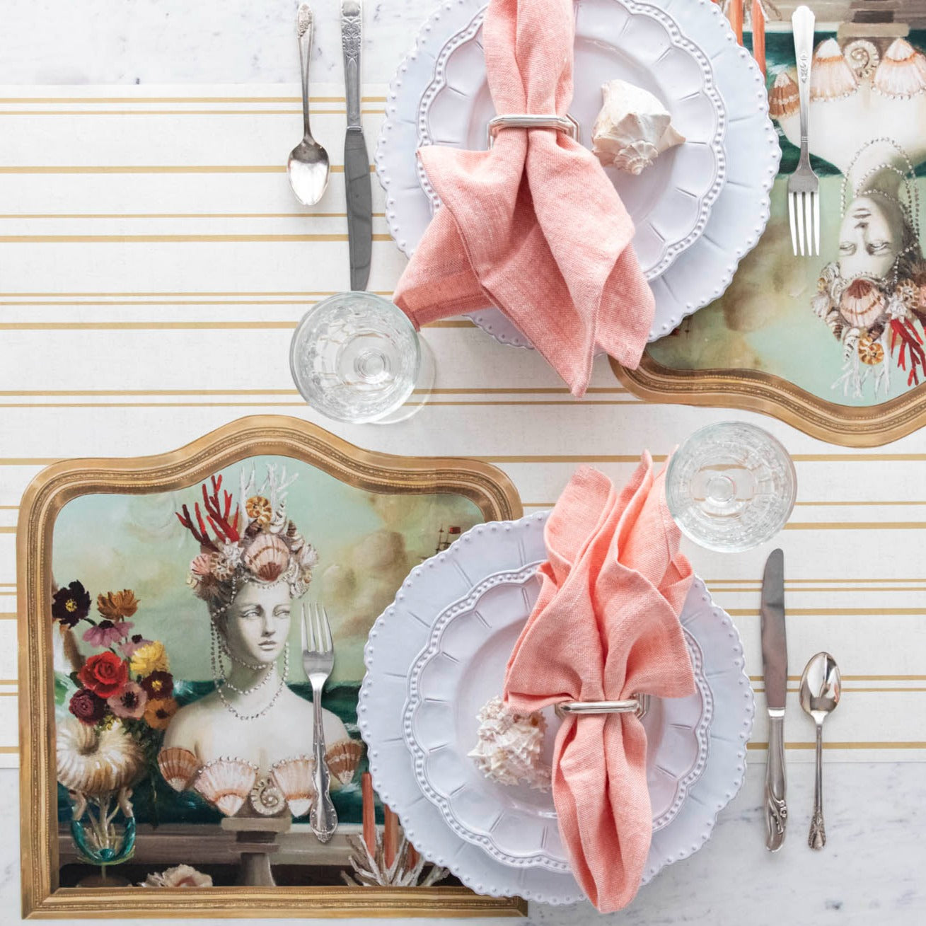 The Die-cut Goddess of the Sea Placemat under an elegant table setting for two, from above.