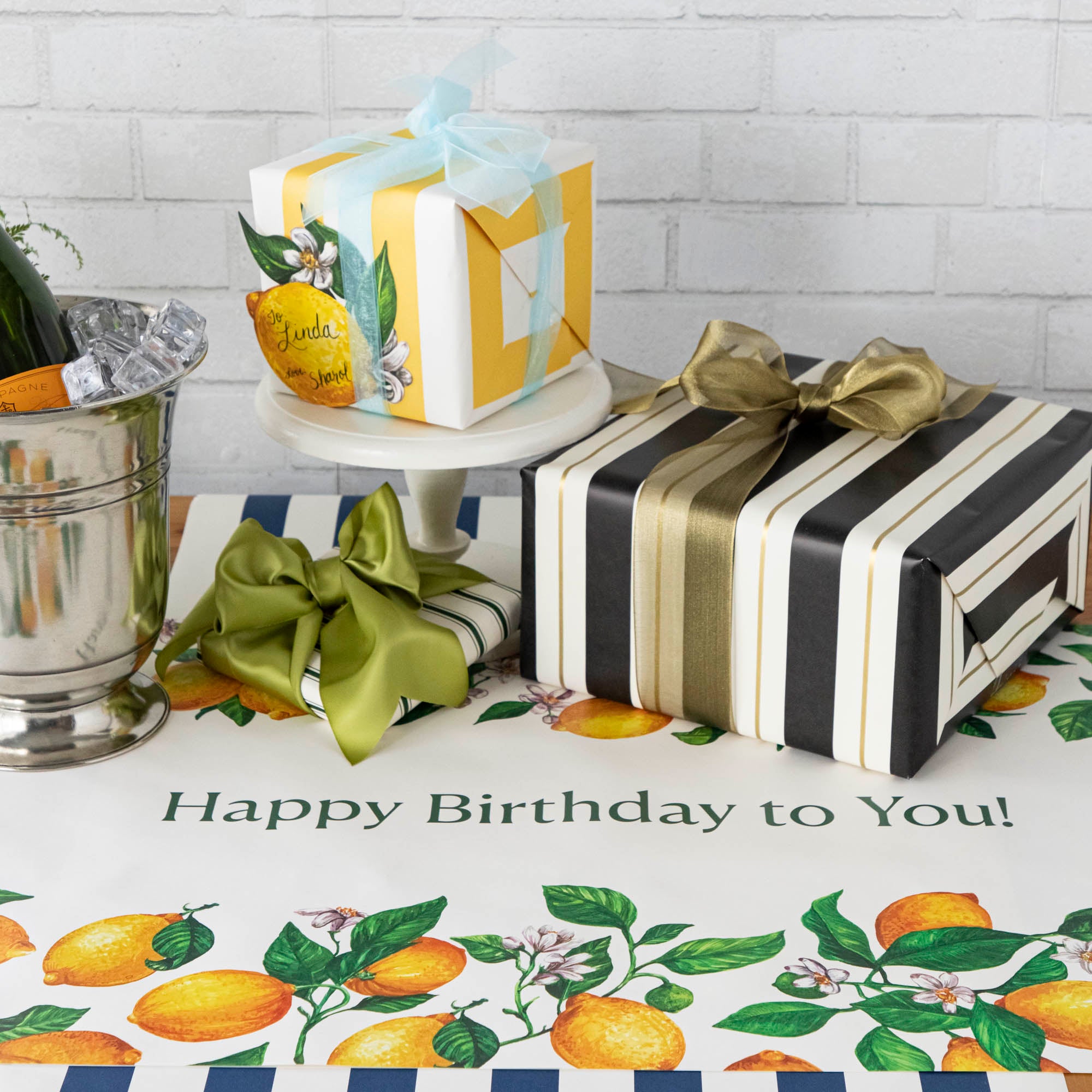 An elegant birthday table with the Lemons Personalized Runner, "Happy Birthday to You!" printed in green down the middle.