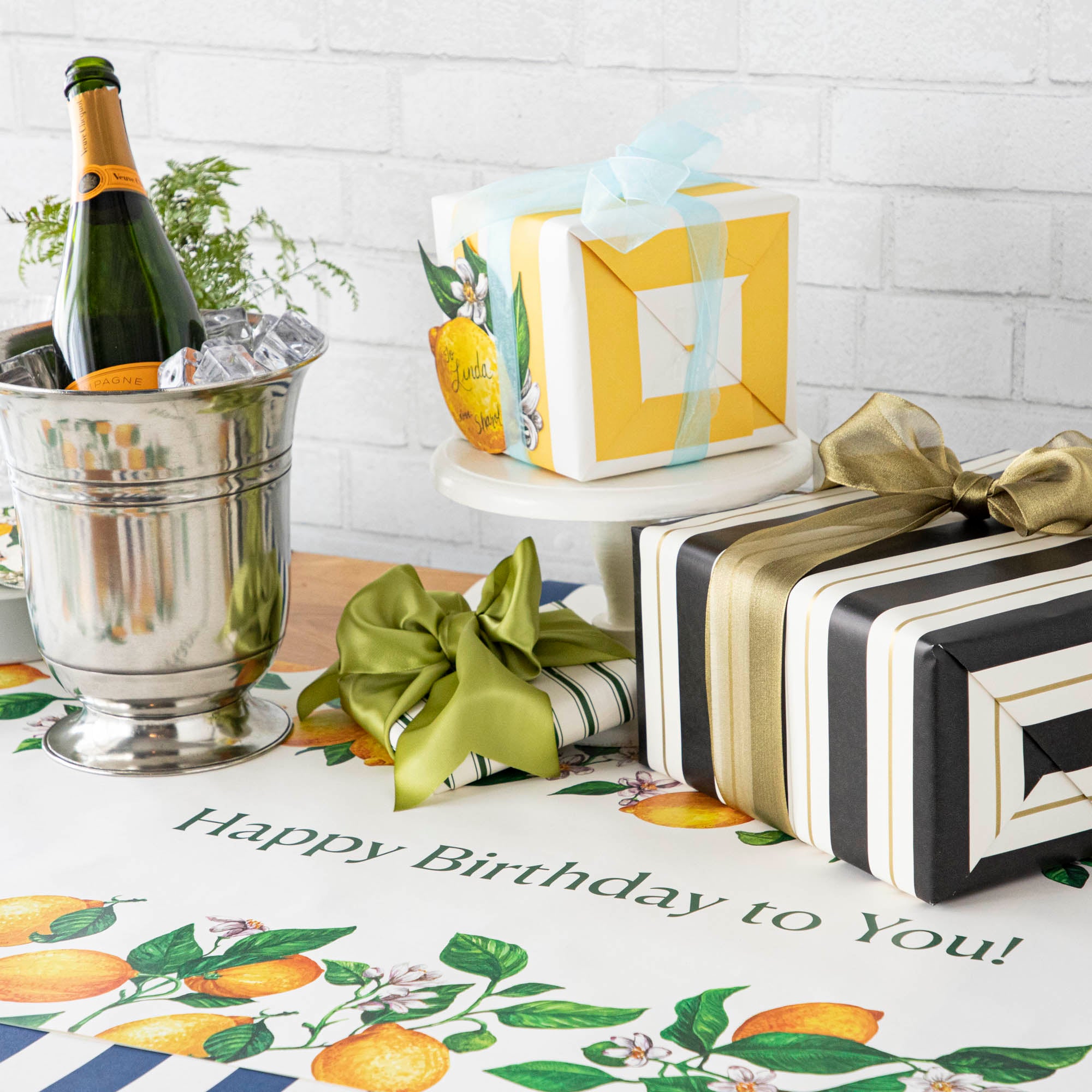 An elegant birthday table with the Lemons Personalized Runner, "Happy Birthday to You!" printed in green down the middle.
