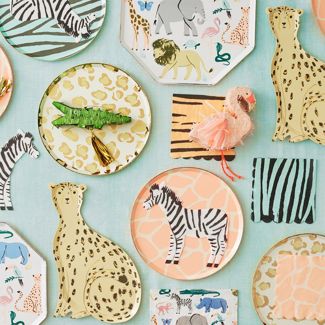 Four Safari Animal Print Paper Napkins with gold foil detail on a white background by Meri Meri.