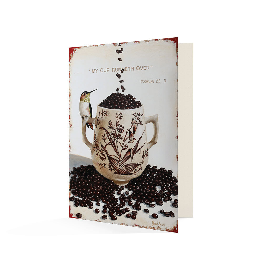 Sentence with product name and brand name: An illustration of the My Cup Runneth Over (Coffee Beans) Notecard surrounded by coffee beans with a hummingbird and the phrase &quot;my cup runneth over - psalm 23:5&quot; written on a handwritten note for that personal, by David Arms.