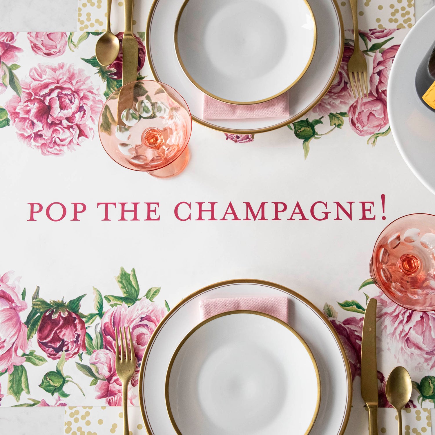 The Peony Personalized Runner, with &quot;POP THE CHAMPAGNE!&quot; printed down the middle in dark pink, under an elegant table setting.