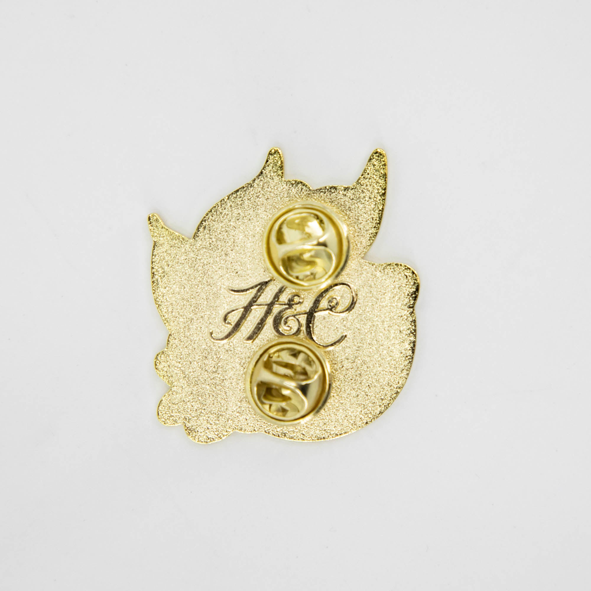 A Lemon Enamel Pin with a monogram on it by Hester &amp; Cook.