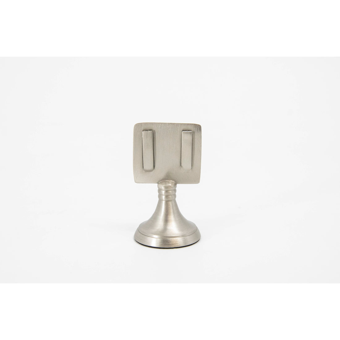 An elegant, silver, short round stand topped by a flat card-holder with two flat prongs, holding a place card reading &quot;Francis&quot;.