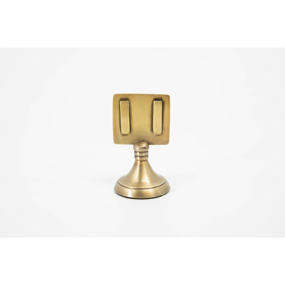 An elegant, brass, short round stand topped by a flat card-holder with two flat prongs.