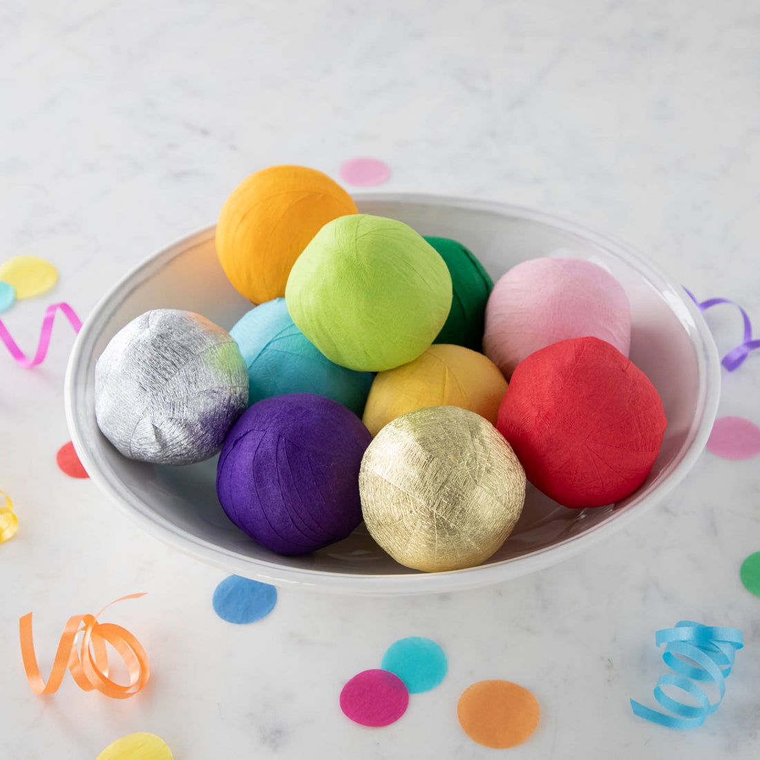 Vintage-inspired Mini Surprize Balls in a white bowl with confetti by Tops Malibu.