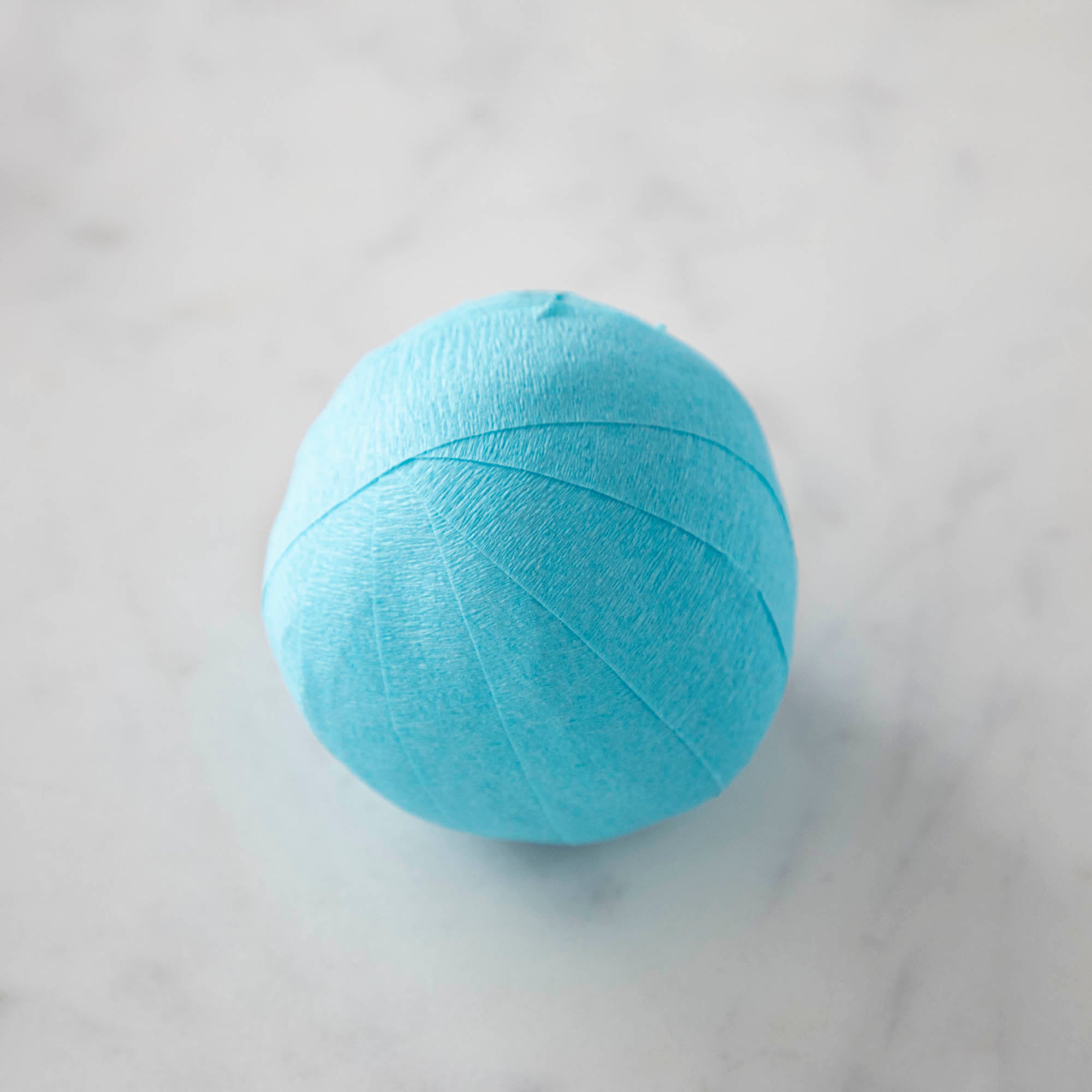 Vintage-inspired Mini Surprize Balls in a white bowl with confetti by Tops Malibu.