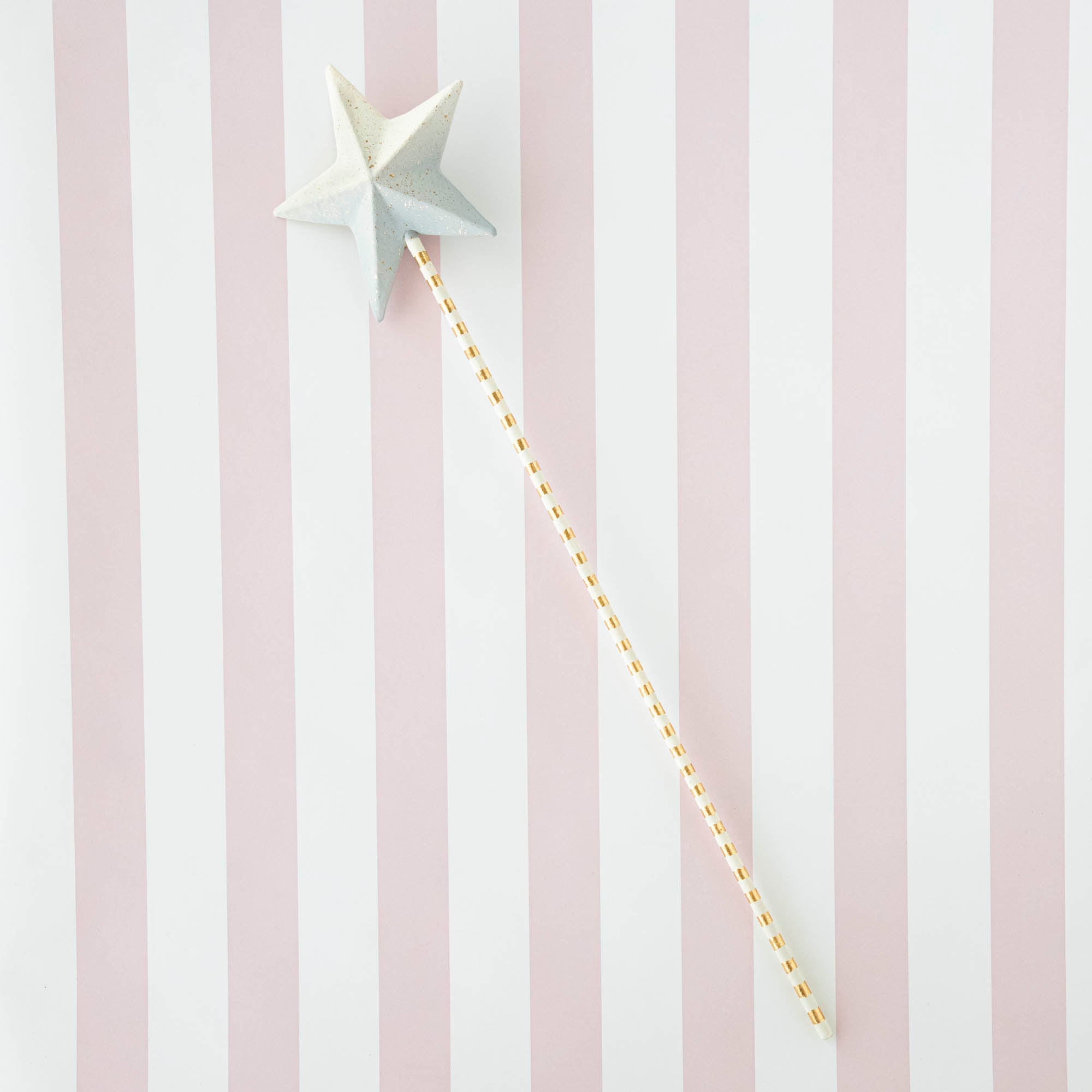 Five Glitterville Magic Wands on a striped background.