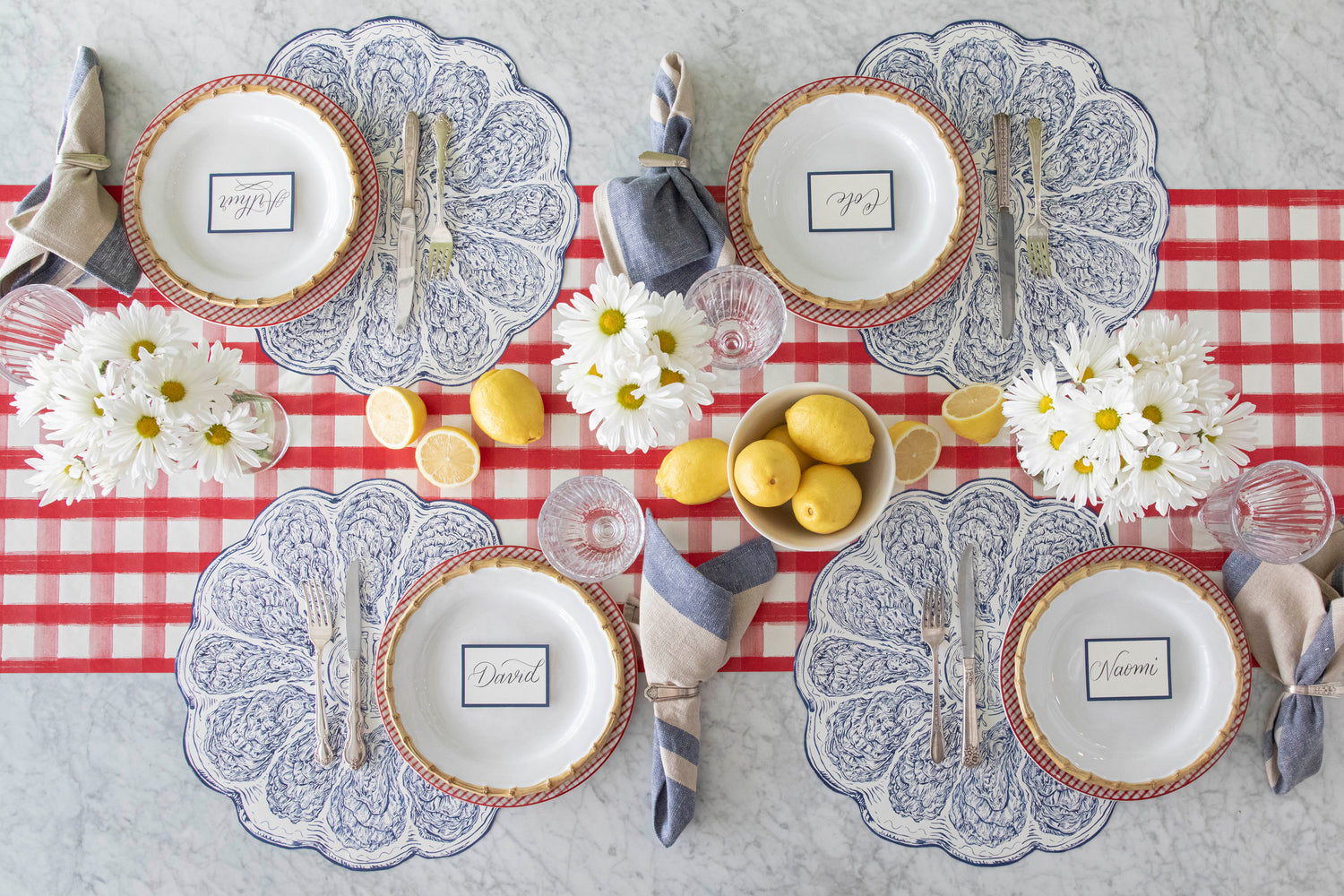 Die-cut Blue Oyster Plate Placemat styled on a summer table.