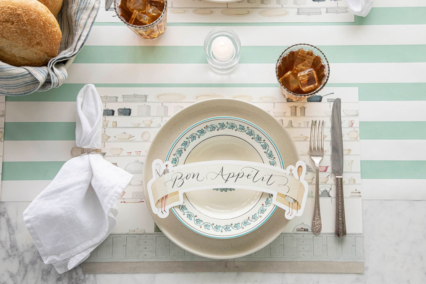 An elegant table setting featuring the Butler's Pantry Placemat, vintage dinnerware, Two Cooks Banner Table Accent and various food on the Seafoam Classic Stripe Runner.