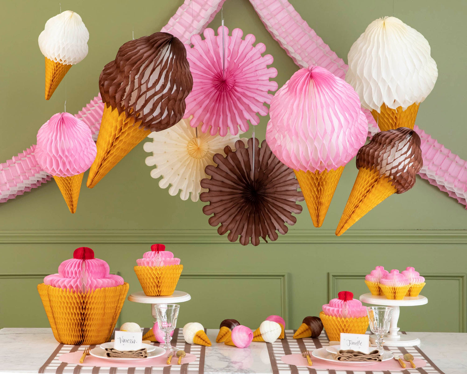 Celebration Honeycomb pieces hung from the ceiling, strung along walls, and styled as centerpieces.