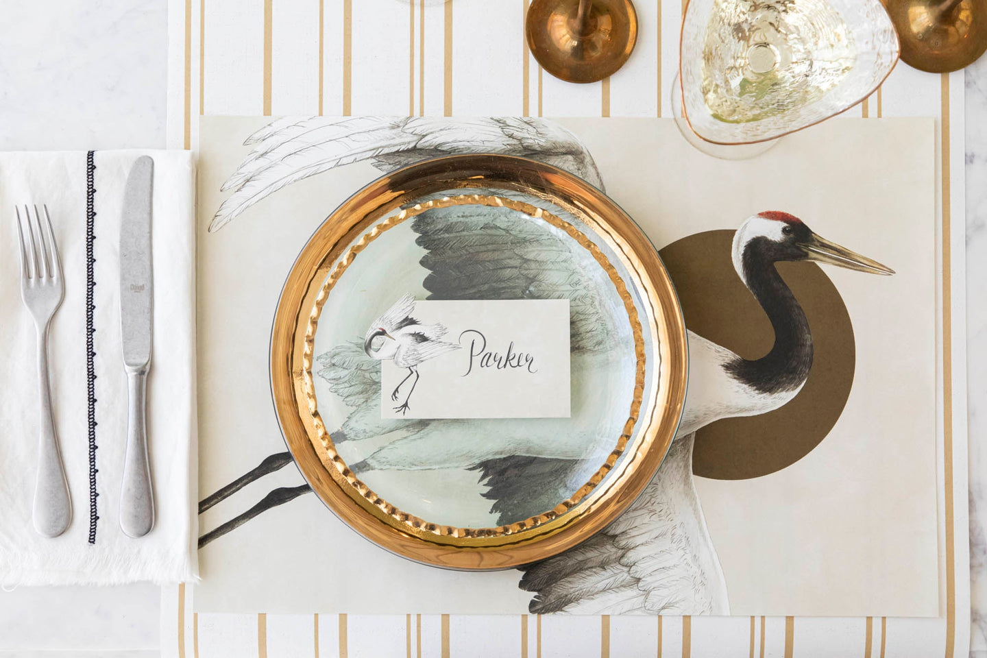 Eastern Crane Placemat on an elegant table setting for one, with the Crane Place Card and Antique Gold Stripe Runner underneath.
