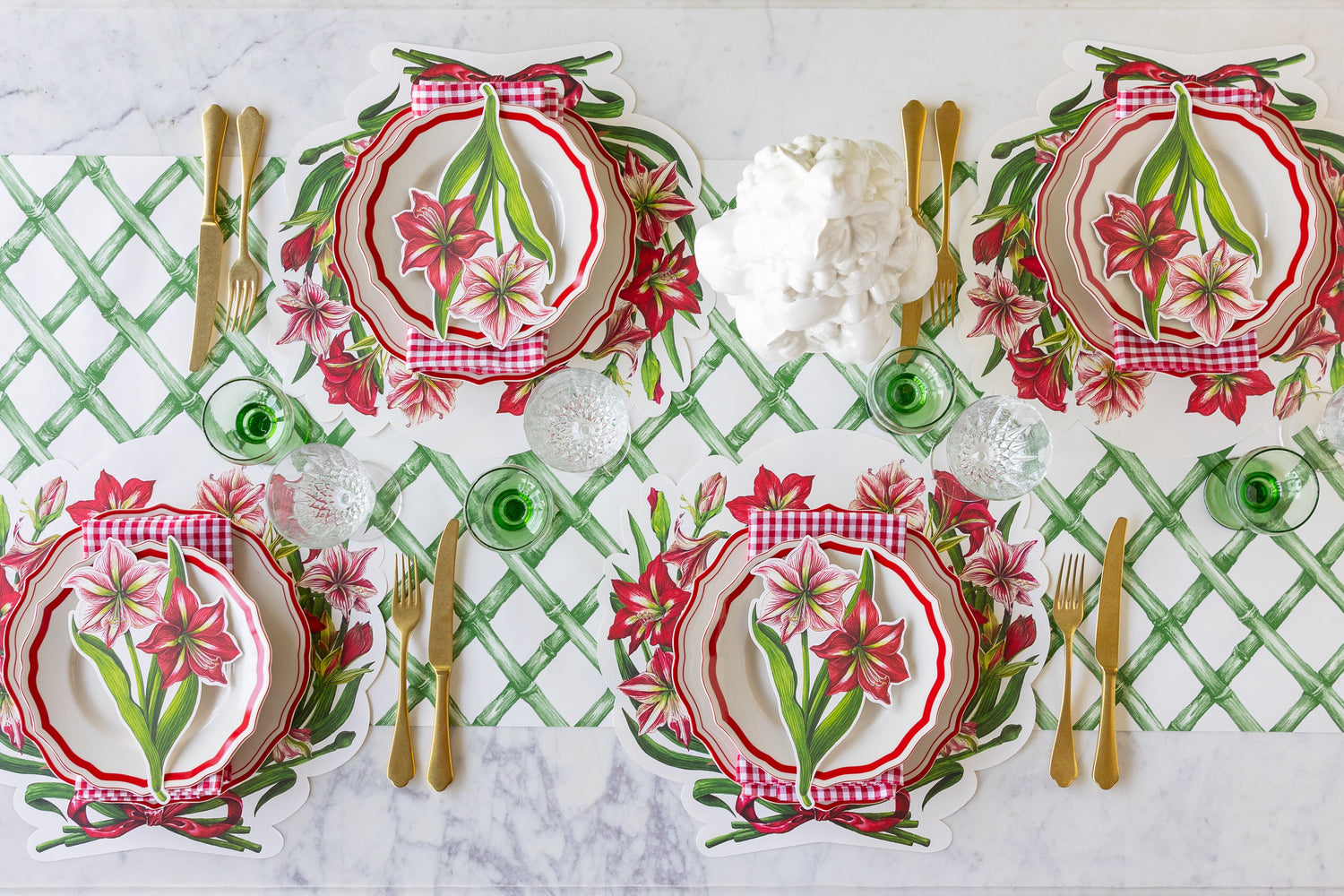 An elegant table setting featuring Die-cut Amaryllis Placemats, Red Icing on the Cake plates, Amaryllis Table Accent and gold flatware on the Green Lattice Runner.