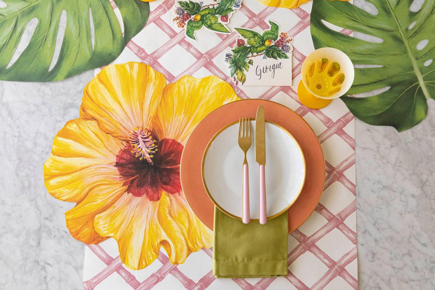 A tropical place setting featuring the Die-cut Hibiscus Placemat and Pink Lattice Runner.