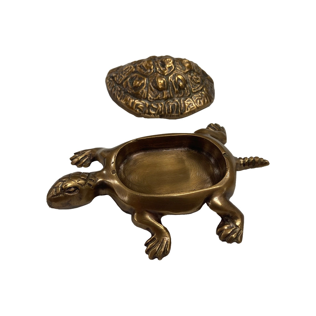 Brass turtle figurine with intricate design on a white background.