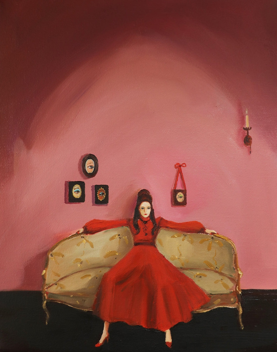 Woman in red dress sitting on a couch with Unladylike Art Prints printed with archival inks by The Mansion Girls on the wall behind her.