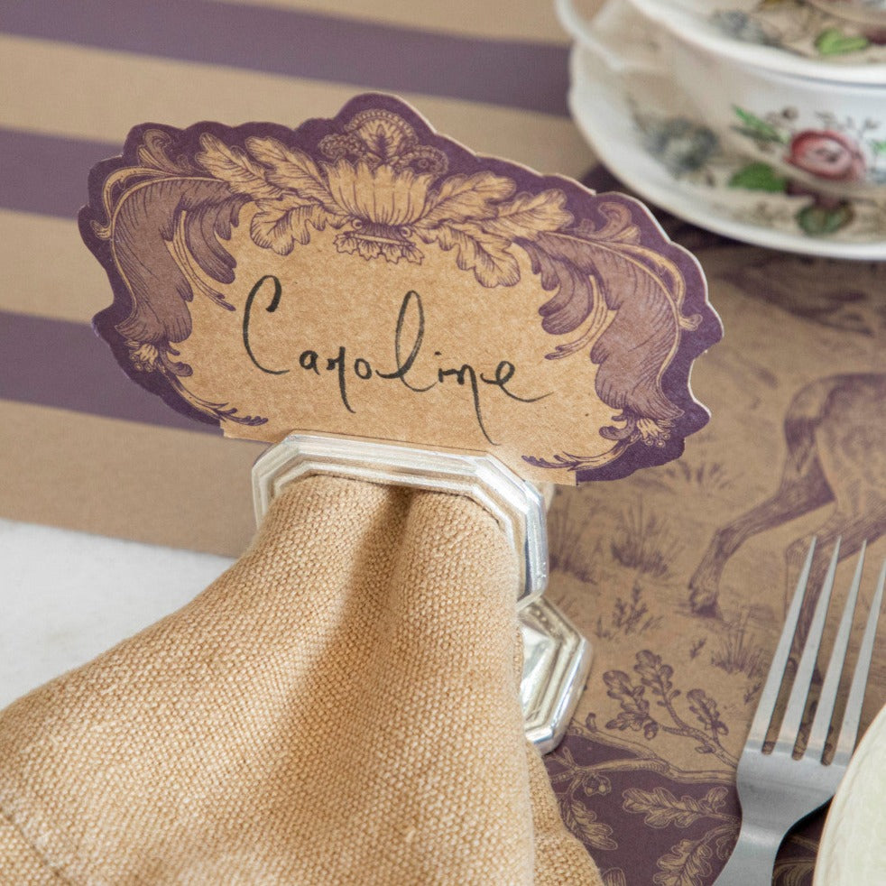 A vintage table setting with a Hester &amp; Cook Napkin Ring with Place Card Holder and napkin.