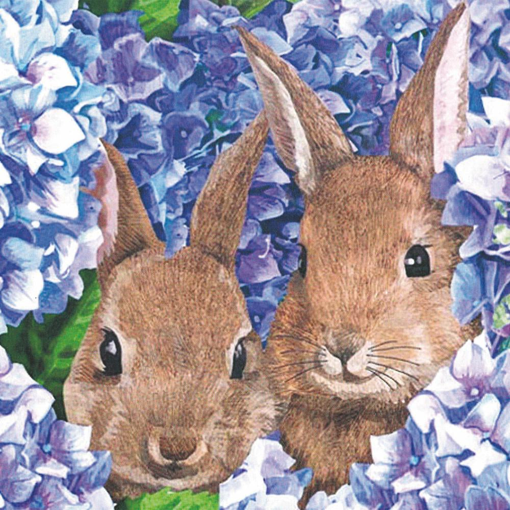 Two rabbits nestled among blue hydrangea blossoms, now known as &quot;Hydrangea Bunnies Beverage Napkins,&quot; perfectly capture the spirit of Easter celebrations from Paper Products Design.