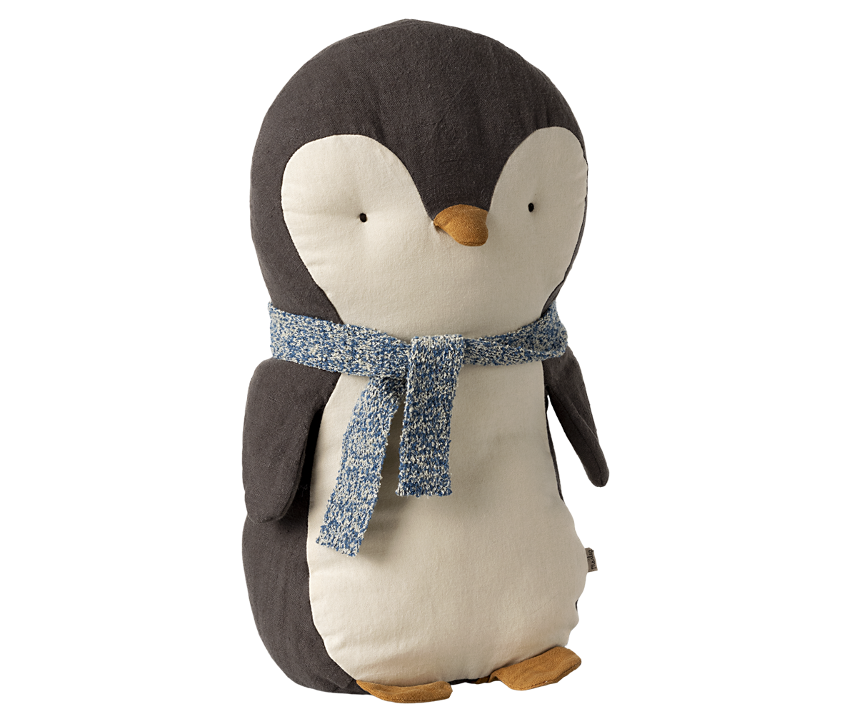 A stuffed animal penguin with a blue scarf tied around his neck.