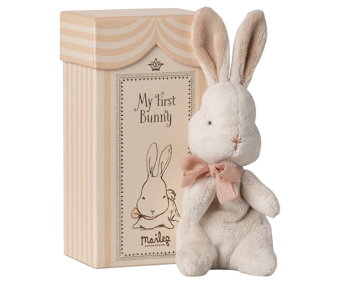 Plush bunny toy with a bow and decorative box labeled &