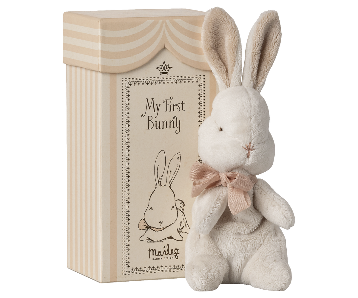 Plush bunny toy with a bow and decorative box labeled &