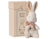 Plush bunny toy with a bow and decorative box labeled &