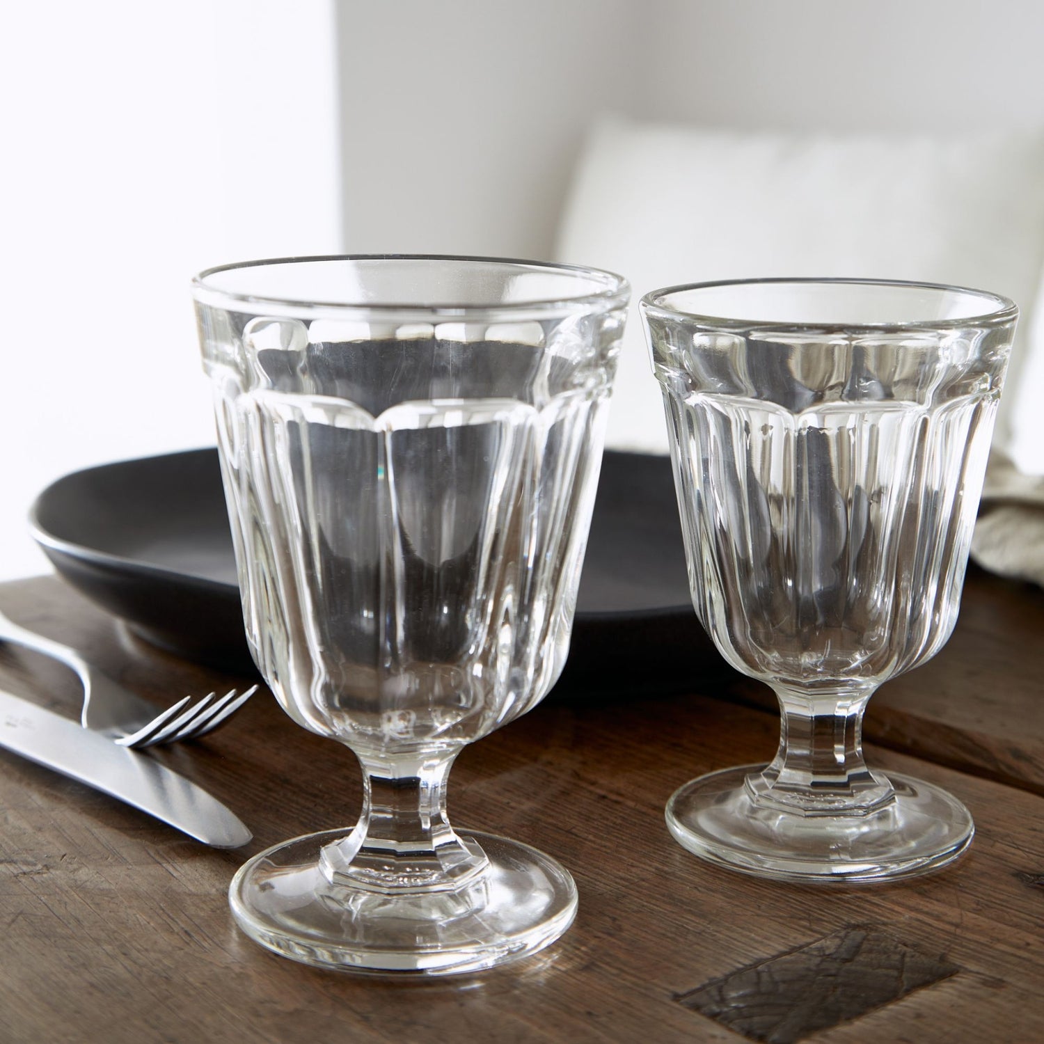 Two Casafina Living Gomos Water Glasses on a wooden table.
