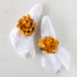 Two white napkins with Fall Mustard Hydrangea Napkin Rings on a marble surface.