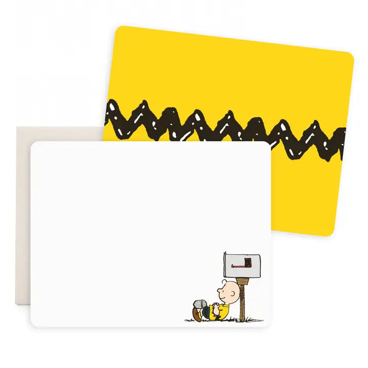 A set of stationery cards featuring the Peanuts character Charlie Brown. One card is solid white with a small illustration of Charlie Brown at a mailbox in the bottom right corner.