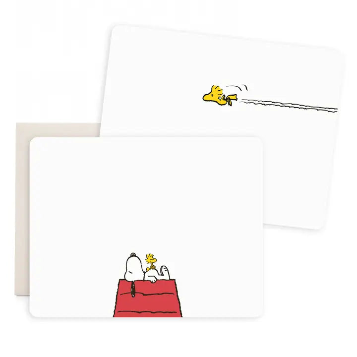 A set of white rectangular cards or envelopes featuring Peanuts-style illustrations, including Woodstock flying with a long tail on one card and Snoopy and Woodstock on a red doghouse on another, shown against a light gray background.