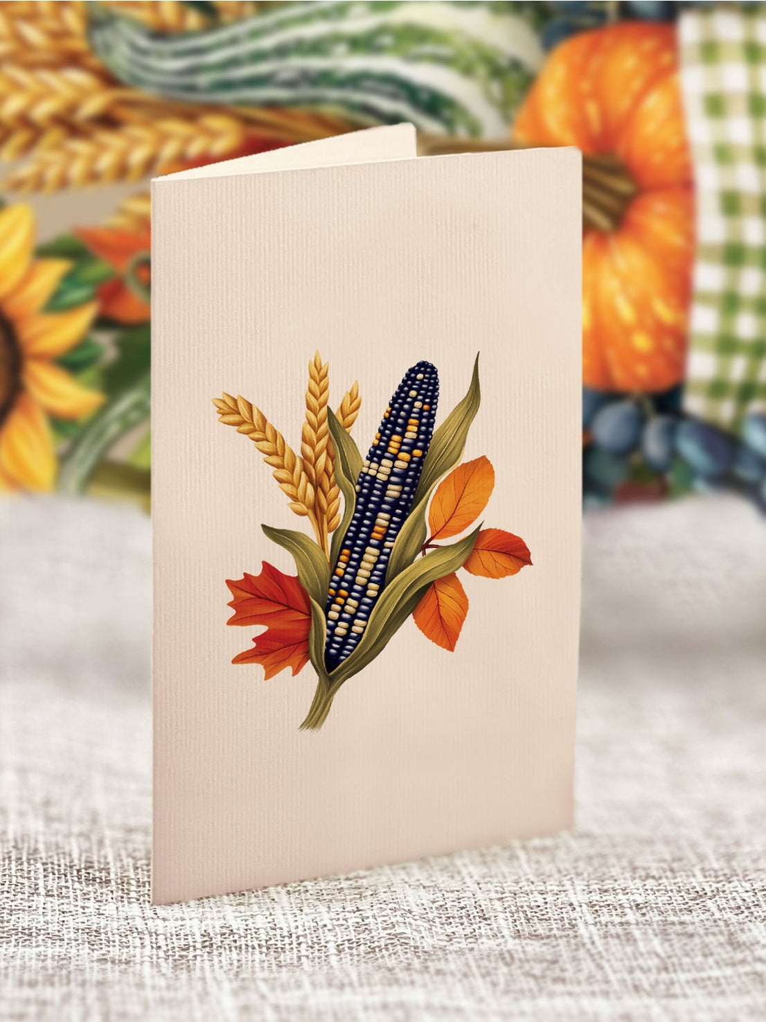 Card with corn and sunflower design on a textured surface with blurred background