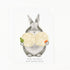 A white greeting card featuring a watercolor illustration of a gray rabbit holding two large, round, pale yellow matzo balls, with the text &