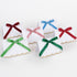 Six white place cards with colorful ribbons on a white background