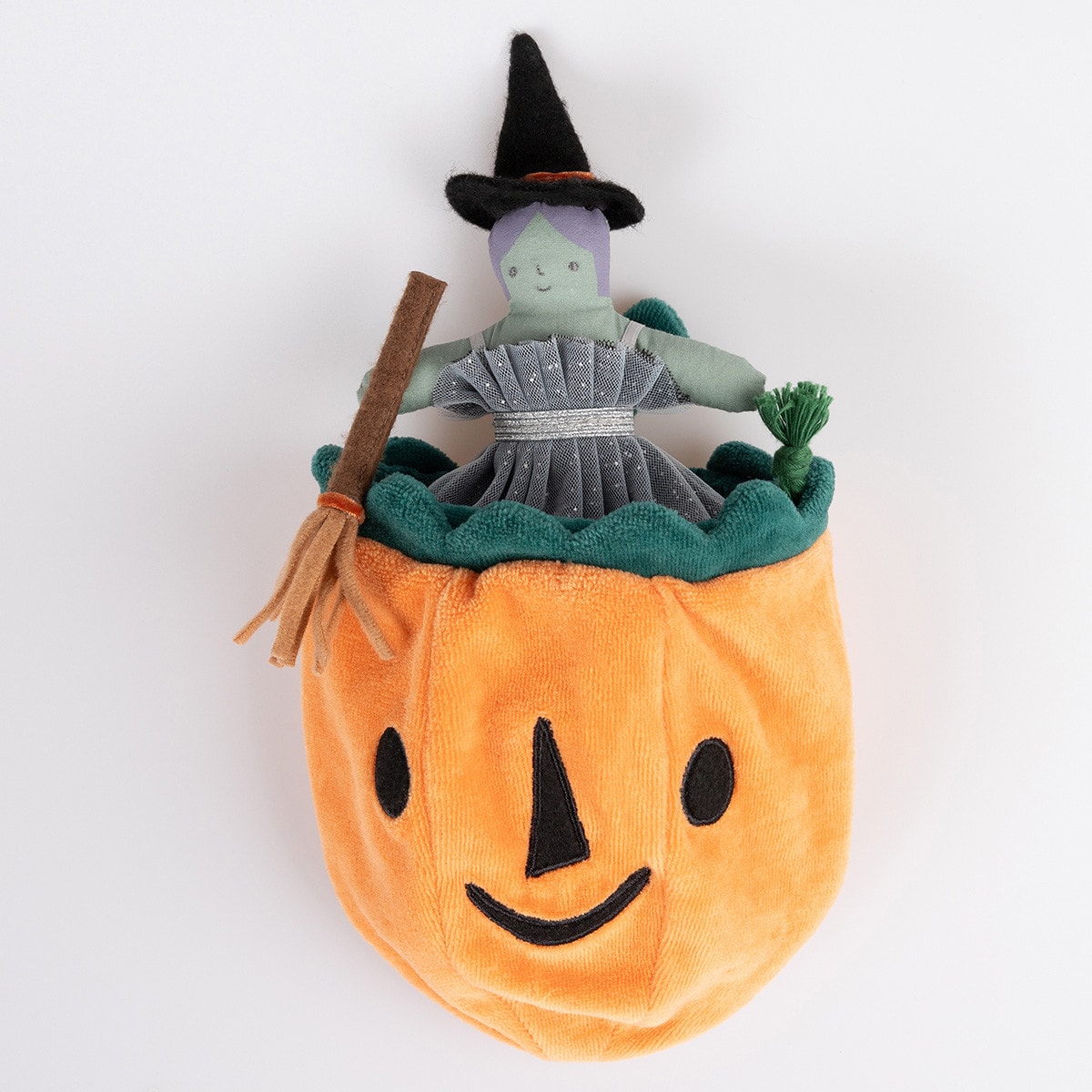 Plush toy with a witch inside a pumpkin on a white background.
