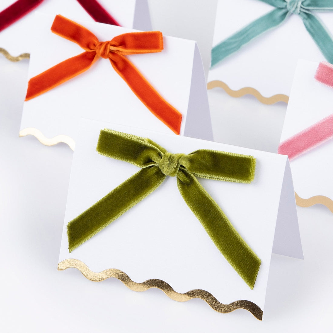 Close up of green velvet bow place card. 