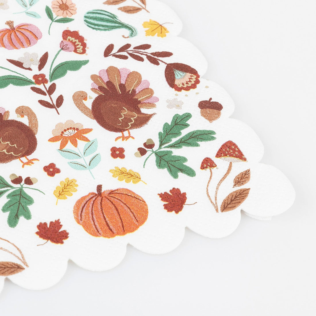 Decorative paper napkin with autumn-themed design including turkeys, pumpkins, and leaves on a white background.
