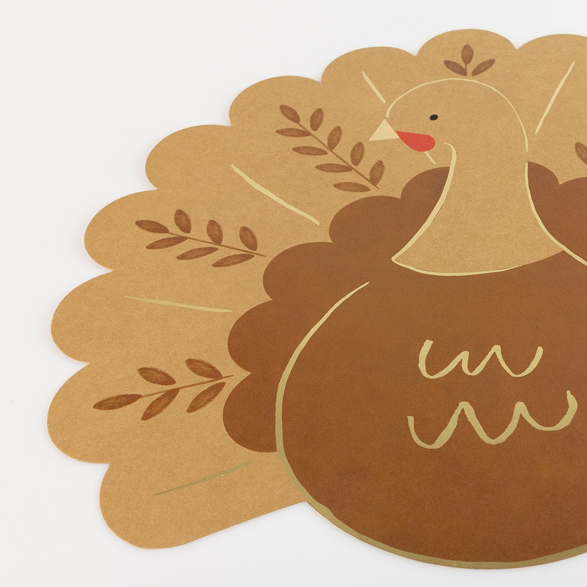Paper placemat shaped like a turkey with gold details. 