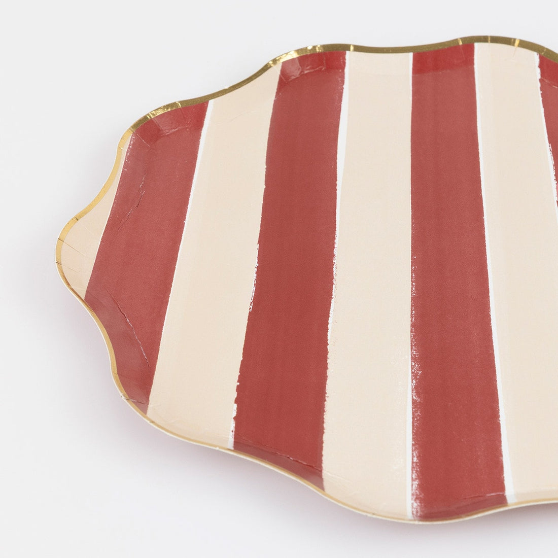 Red and white striped paper plate with gold rim on a white background. 